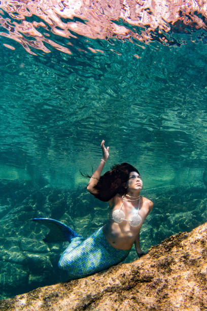 istock Mermaid swimming underwater in the deep blue sea 863578452
