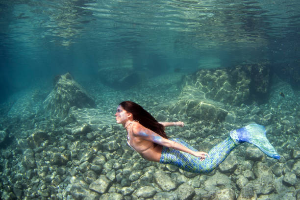 istock Mermaid swimming underwater in the deep blue sea 863578592