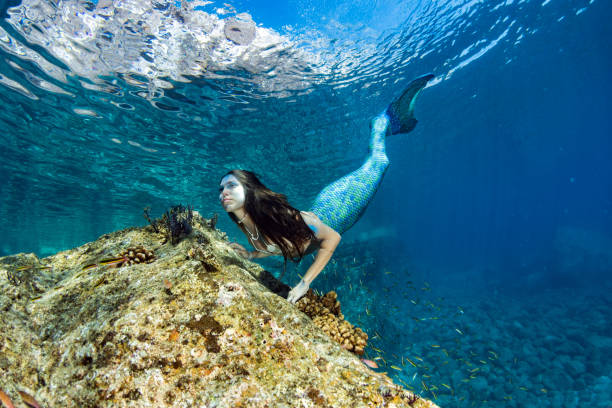 istock Mermaid swimming underwater in the deep blue sea 863578620