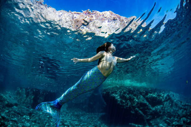 istock Mermaid swimming underwater in the deep blue sea 863578664