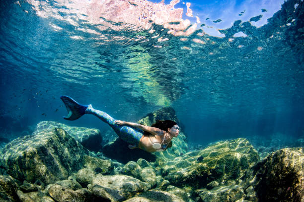 istock Mermaid swimming underwater in the deep blue sea 863580844