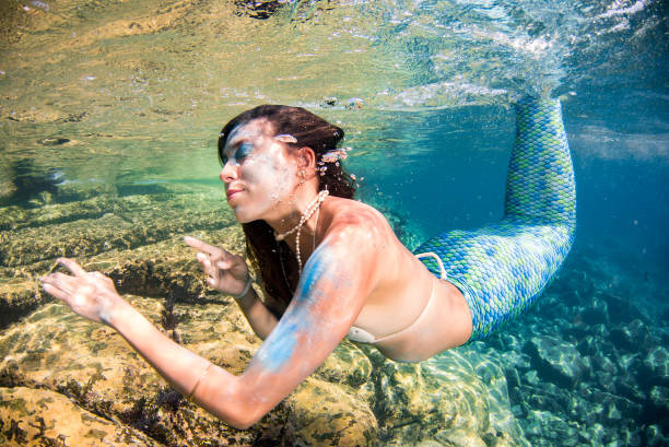 istock Mermaid swimming underwater in the deep blue sea 863581556