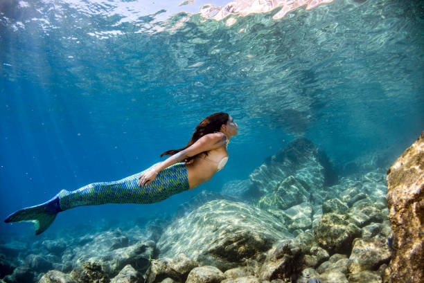 istock Mermaid swimming underwater in the deep blue sea 863583016