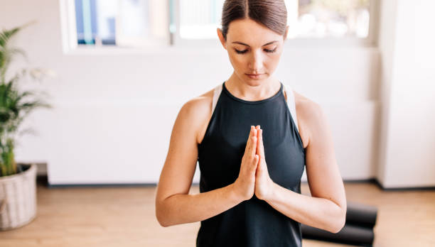 istock Young woman in namaste yoga pose 863583318