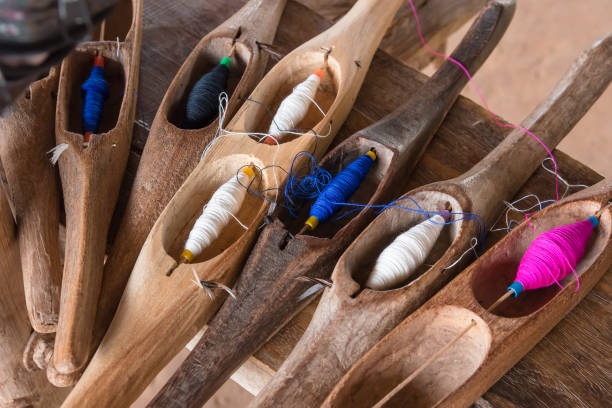 istock Colorful sewing thread in a wooden tube. 863583454
