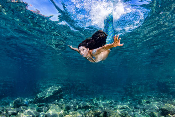 istock Mermaid swimming underwater in the deep blue sea 863583466