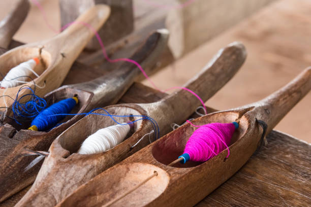 istock Colorful sewing thread in a wooden tube. 863583758