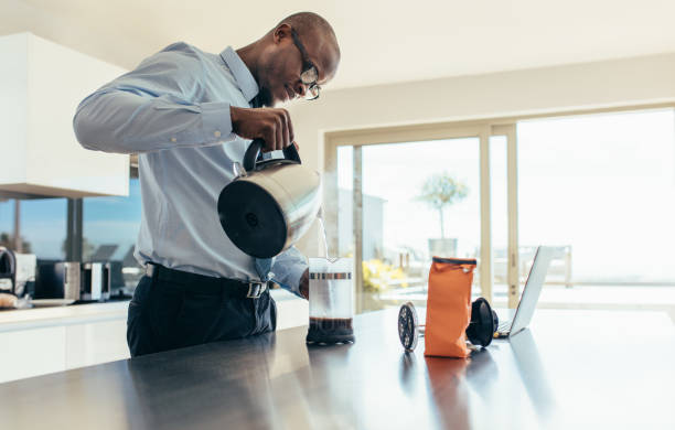 istock Businessman preparing coffee at home 863583822