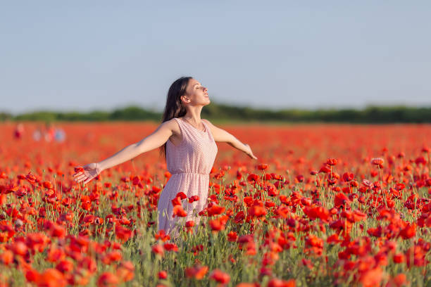 istock Girl at blooming poppy field 863586706