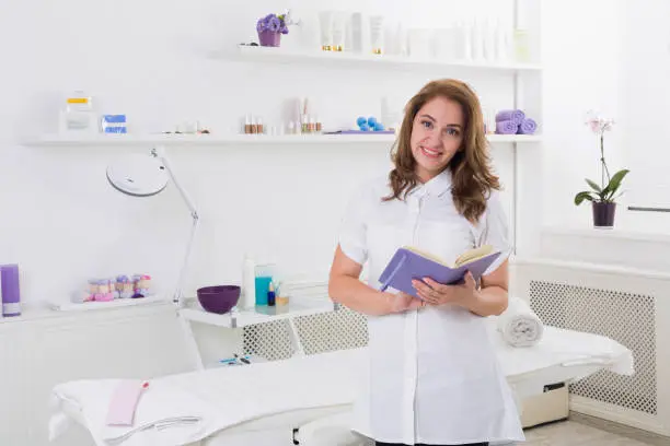 Woman beautician doctor at work in spa center. Portrait of a young female professional cosmetologist. Female employee in cosmetology cabinet or beauty parlor. Healthcare occupation, medical career