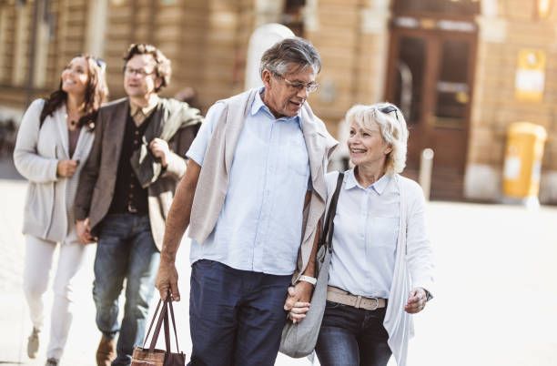 istock Mature Couples Walking Around Old Town 863604470