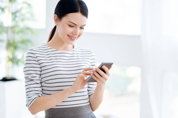 istock Joyful attractive woman using her smartphone 863617886