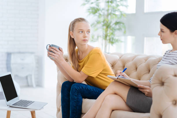 istock Serious young woman having a psychological session 863620646
