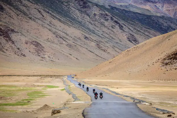 Motorcyclists on the road through Changthang plateau in Ladakh region of Kashmir, India