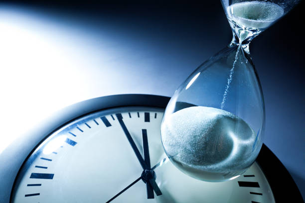 istock Deadline and Out of Time: Sand Timer Hourglass and Clock at Midnight 863624344