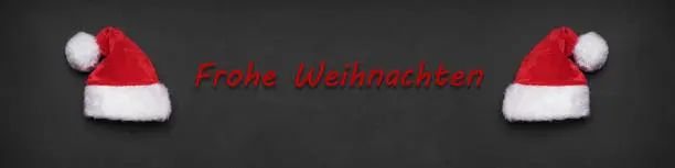 Frohe Weihnachten german christmas greeting banner or header with two santa hats