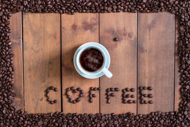 istock Top view cup of coffee with coffee beans square frame on wooden background. 863661836