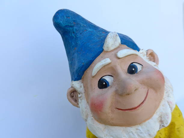 istock Funny garden dwarf with blue hat makes seaside holidays 863670546