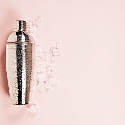 Cocktail shaker on pink background
