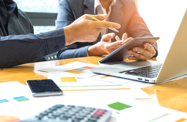 istock Two businessmen have pen and tablet in hand. 863671346