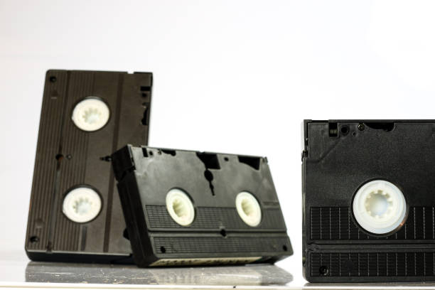 istock Old good video cassettes. Dusty family recordings on solid data carriers, white isolated background. 863681256
