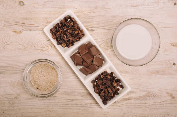 istock Chocolate bar and dried grapes in white bowl 863685160
