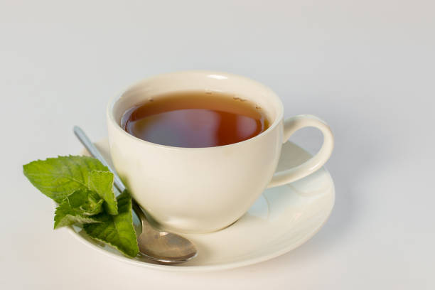 istock cup of tea with mint leaves on white background 863685564