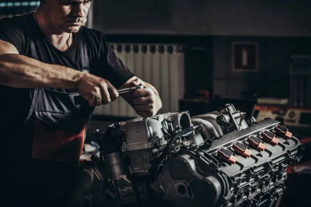 Repairing V10 engine in auto repair shop