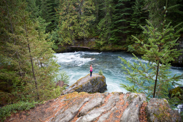 istock Female in pink on a rock doing some Yoga 863693774