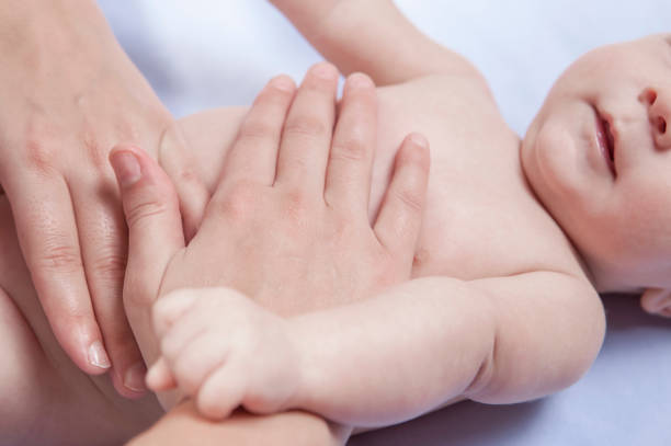 istock Three month baby boy abdomen massage 863706704