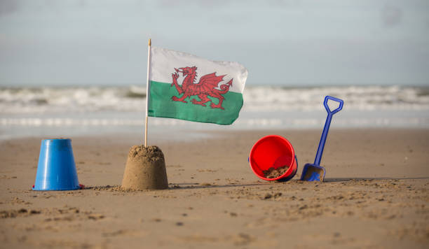 istock Welsh flag in a sandcastle with bucket and spade 863713080