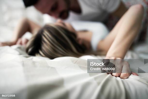 Young Attractive Couple Having Romantic Time In Bed Stock Photo - Download Image Now