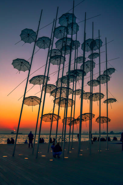 View of the "Umbrellas" sculpture  created  by the sculptor Georgios Zoggolopoulos, located at the seafront of the city. stock photo