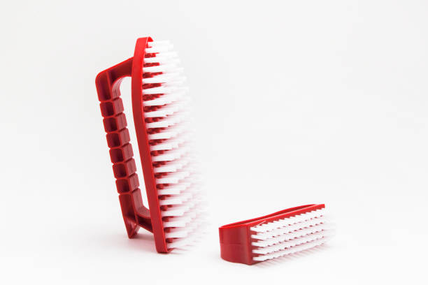 istock Red brush for cleaning shoes on a white background 863729180