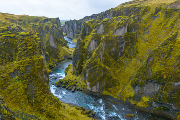 Natural landmark in Iceland. Canyon with rocky cliffs and river.