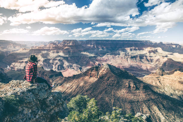 istock Young Woman Overlooking The Grand Canyon 863739652