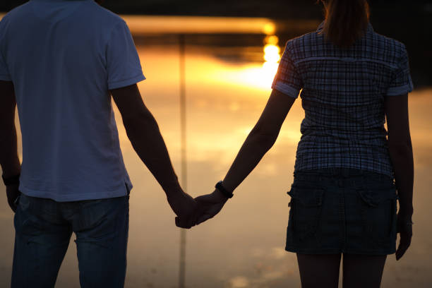 istock Couple enjoying sunset at lake pier 863739918