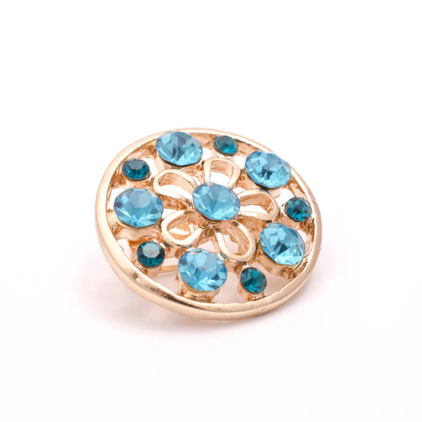 istock gold round brooch with blue diamonds isolated on white 863743528