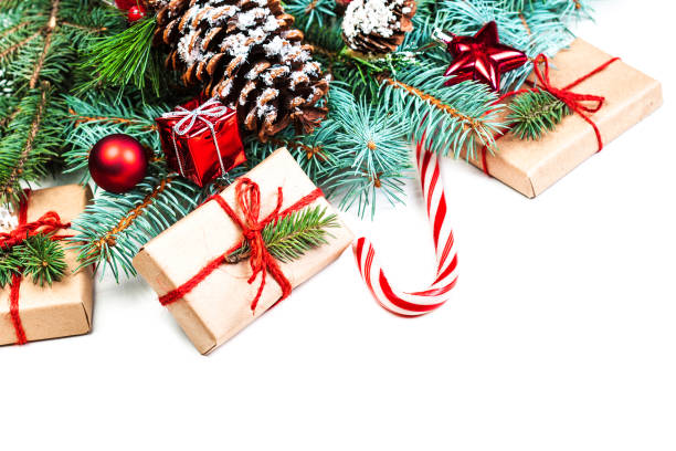 istock Christmas or New Year decorations background with pine cones, fir branches and gift boxes isolated on white. Vintage Merry Christmas concept. Flat lay, top view