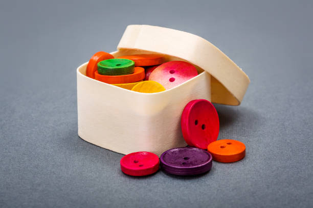 Small wooden box with colorful vintage buttons