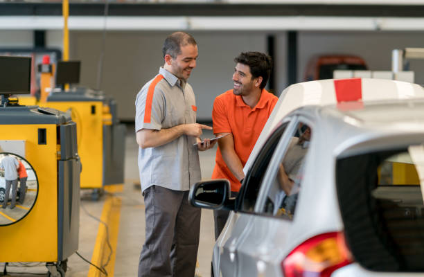 istock Mechanics working at an auto repair shop fixing a car 863753230