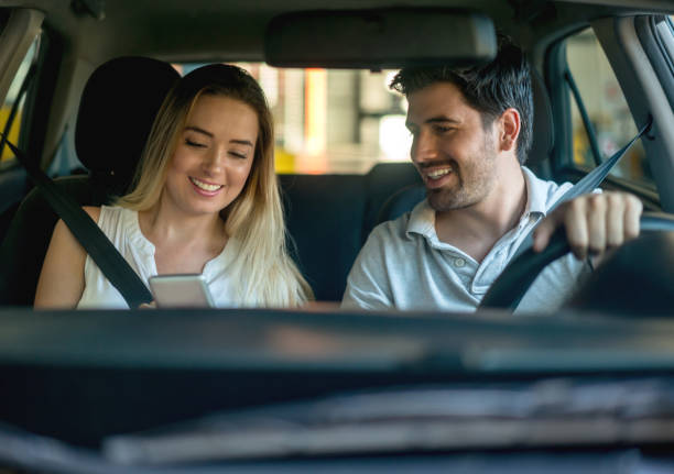 istock Couple driving a car and using the GPS on their cell phone 863753330
