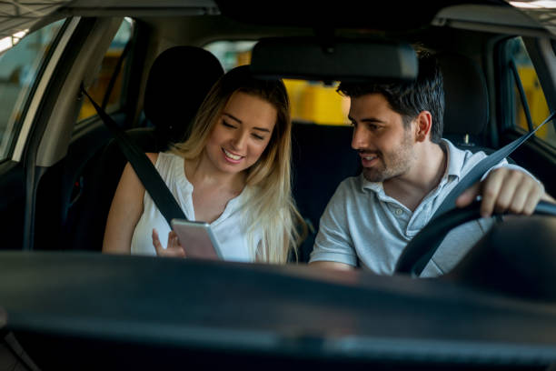 istock Couple driving and using a GPS app on their cell phone 863753466