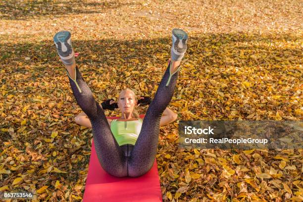 Fitness Woman Training Outside In Autumn Park Sport Woman Doing Exercises During Workout Stock Photo - Download Image Now