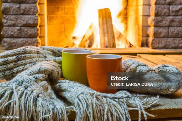 Mugs For Tea Or Coffee Wool Things Near Cozy Fireplace Stock Photo - Download Image Now