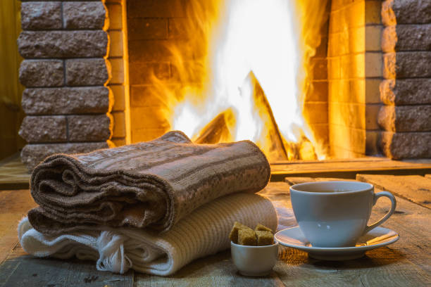 istock Cup of tea with sugar,  wool things near  cozy fireplace. 863785604