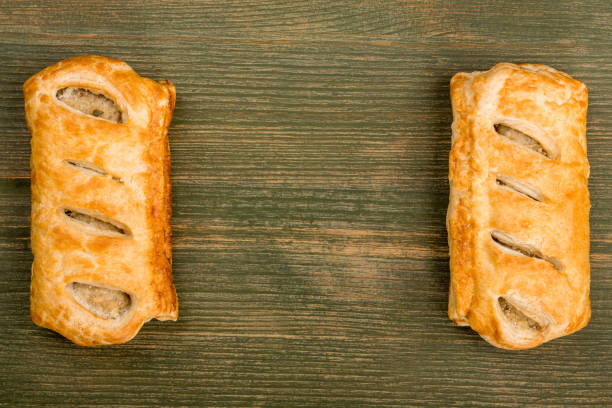 Sausage Rolls in Pastry Sausage Rolls in Pastry On A Green Wooden Background With Copy Space sausage roll stock pictures, royalty-free photos & images