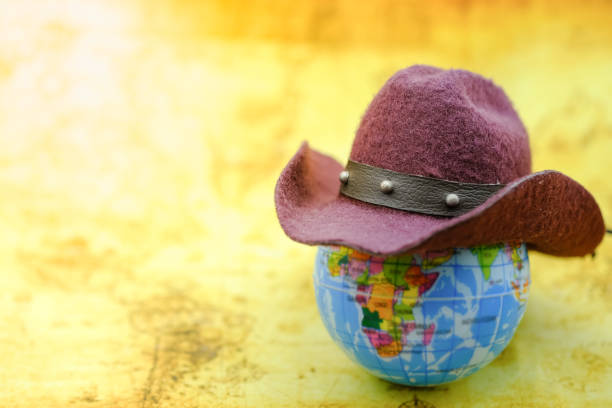 istock Travel Concept. Brown hat on mini world ball on map. 863813668