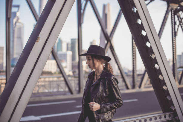 istock Girl in biker jacket standing on the bridge 863822526