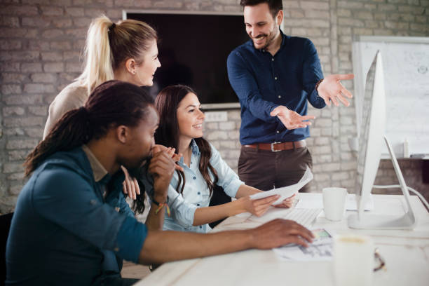 istock Group of young designers working as team 863825972